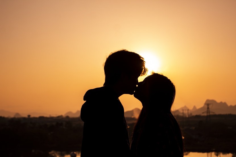 夕阳下亲吻的情侣摄影